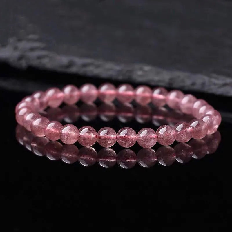Women's strawberry quartz bracelet with polished beads in 6mm, 8mm, or 10mm sizes