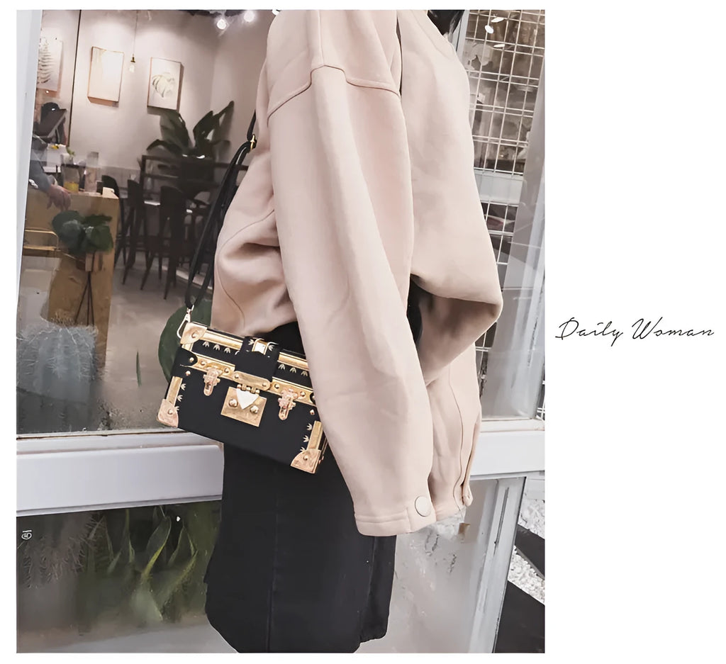 Women's hard PU shoulder bag with flap closure and crossbody strap in black colour with rivet decoration
