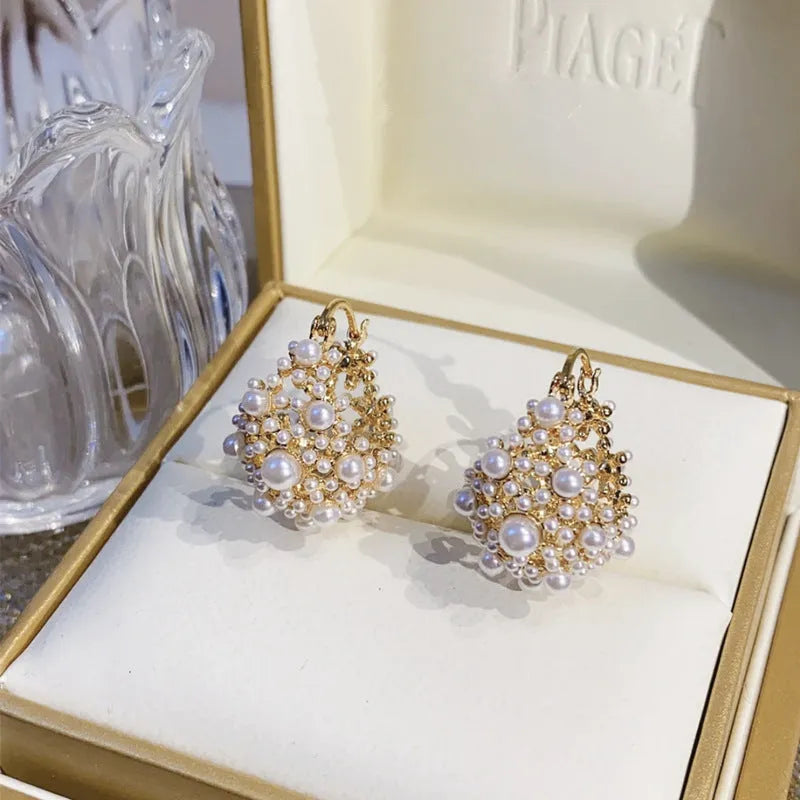 Gold floral basket-shaped women's earrings made from small rice beads with pearl inlay on copper.