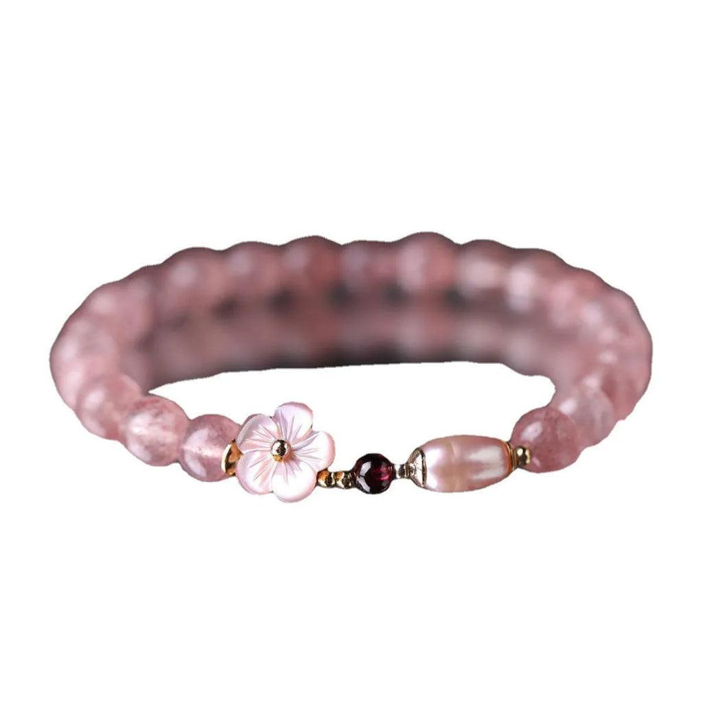 Strawberry quartz peach blossom bracelet with crystal flower charm and gemstone beads.