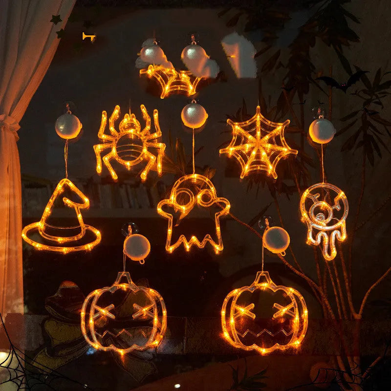 Seven Halloween LED window lights with spider, pumpkin and ghost designs on suction cups