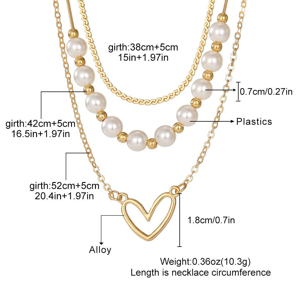 Vintage gold heart pendant necklace with pearl chain detailing showing adjustable length feature