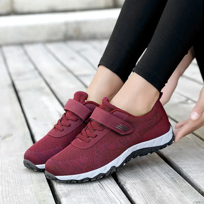 Women's gray purple low-top casual shoes with velcro strap and wedge heel.
