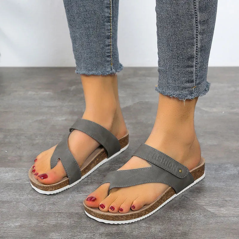 Flat toe ring thick-soled flip-flop in a solid colour on a plain background
