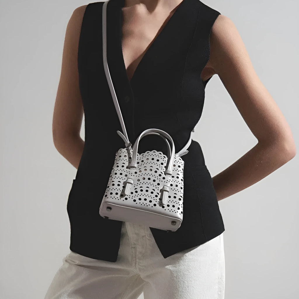 Hollow carved PU messenger bag with three shoulder straps in horizontal square shape