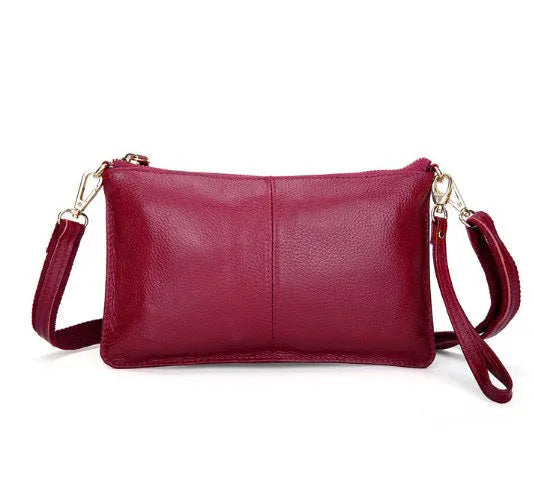 Structured cowhide lady slant bag in apricot colour with hand strap and shoulder strap, showing slim profile.