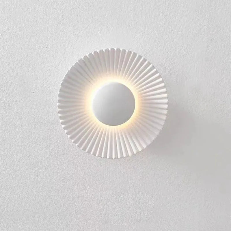 Round aluminium LED wall lamp in a dual-colour finish mounted on a wall.