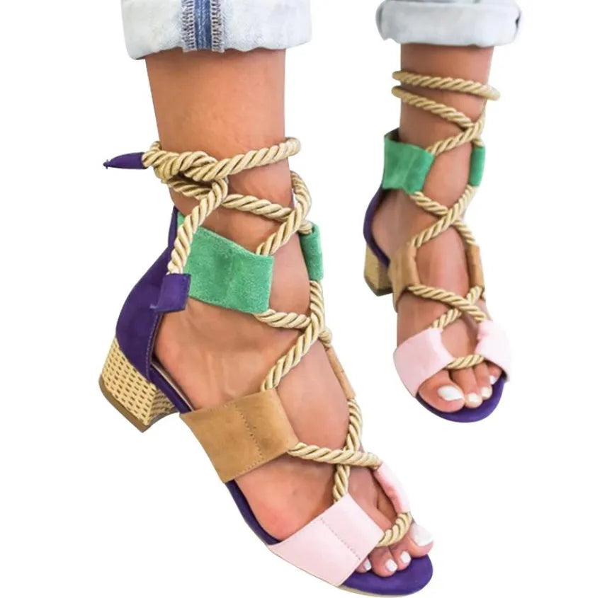 Women's beige suede sandals with thick heel, front strap, and ankle strap on a white background.