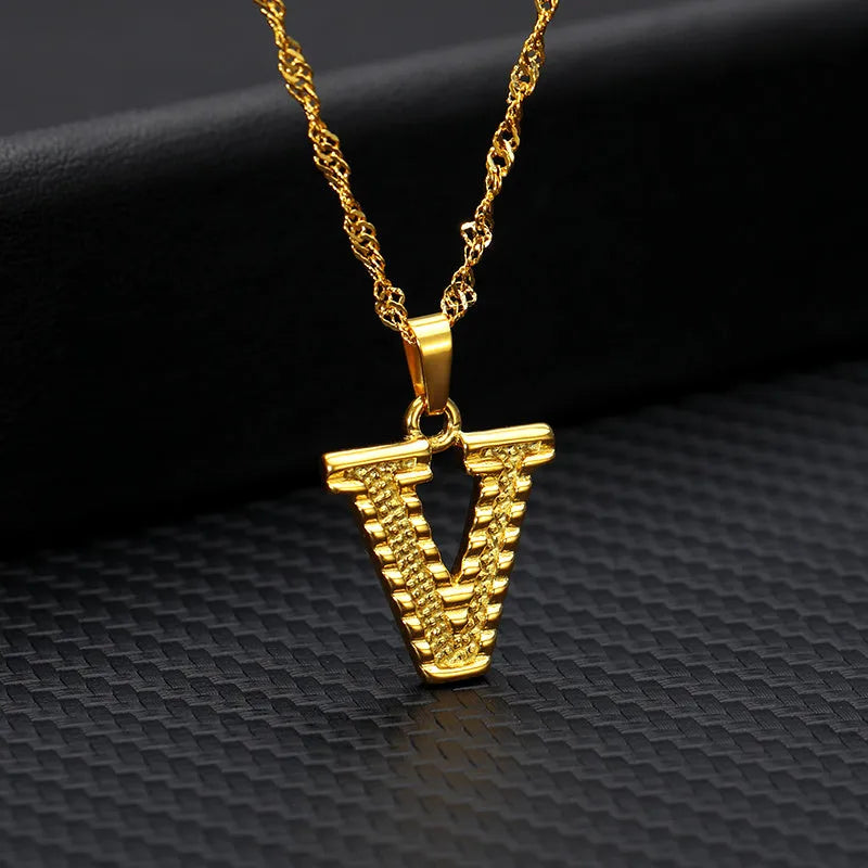 Gold-plated alloy initial pendant necklace with 42cm chain on white background