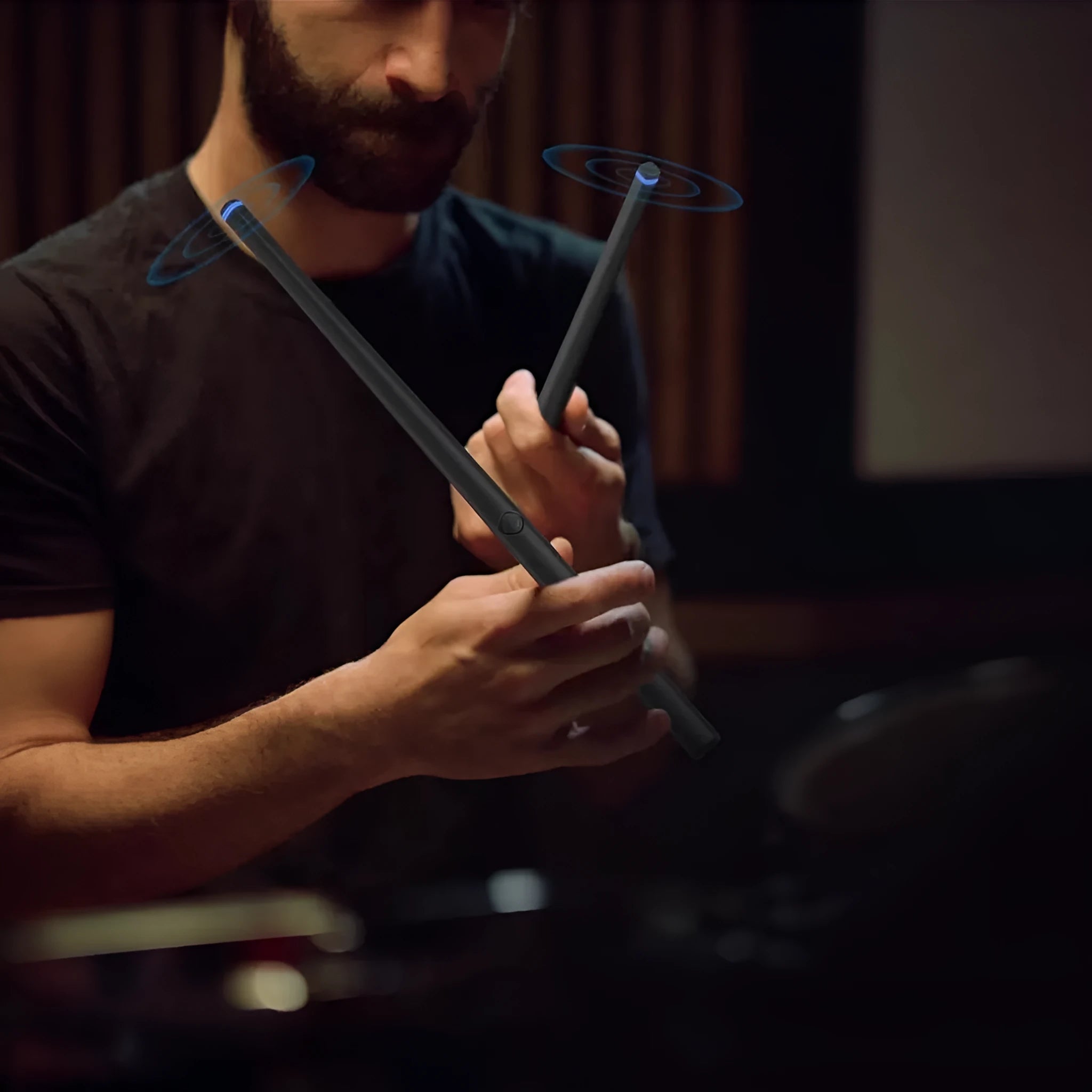 Black wireless somatosensory air drum kit host unit with two drumsticks on a stand.