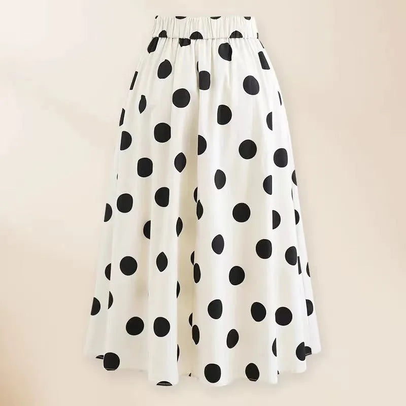 Women's black one-piece swimsuit with a white bow and attached round skirt.