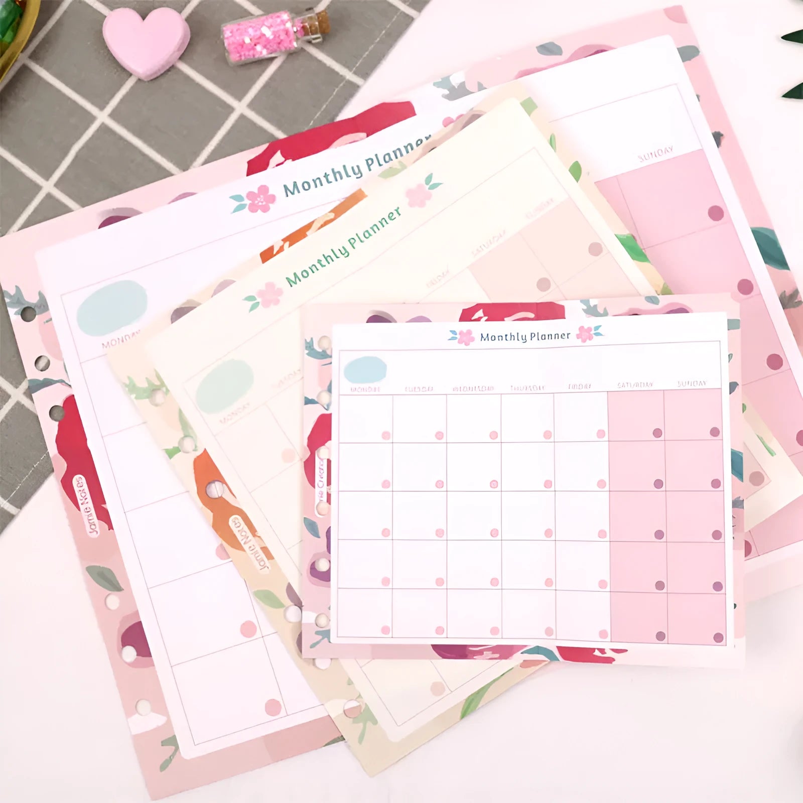 Loose-leaf refill paper sheets showing floral monthly planner and tri-fold schedule layouts in A7, A6, and A5 sizes.