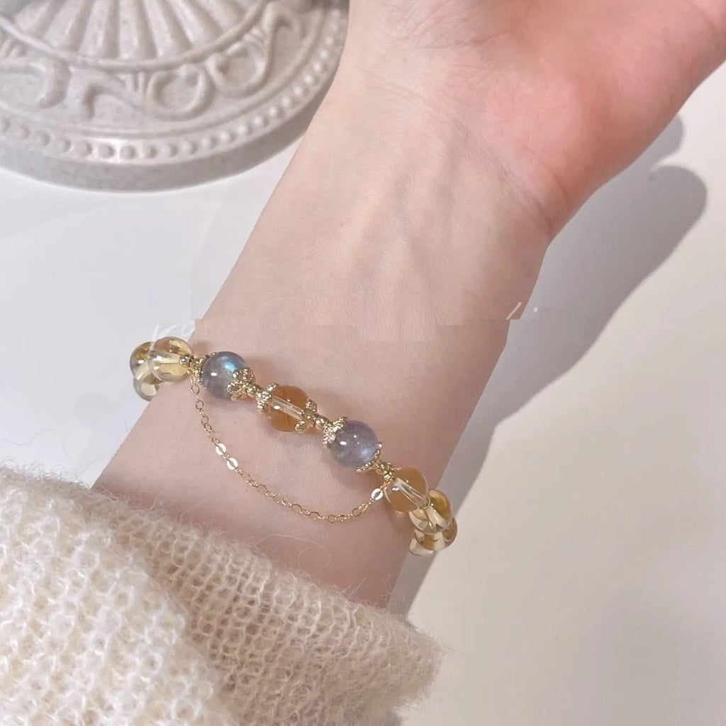Women's crystal bracelet with moonstone and golden sun stone centrepiece, 14K gilded electroplated links, Chinese diamond-shaped style.