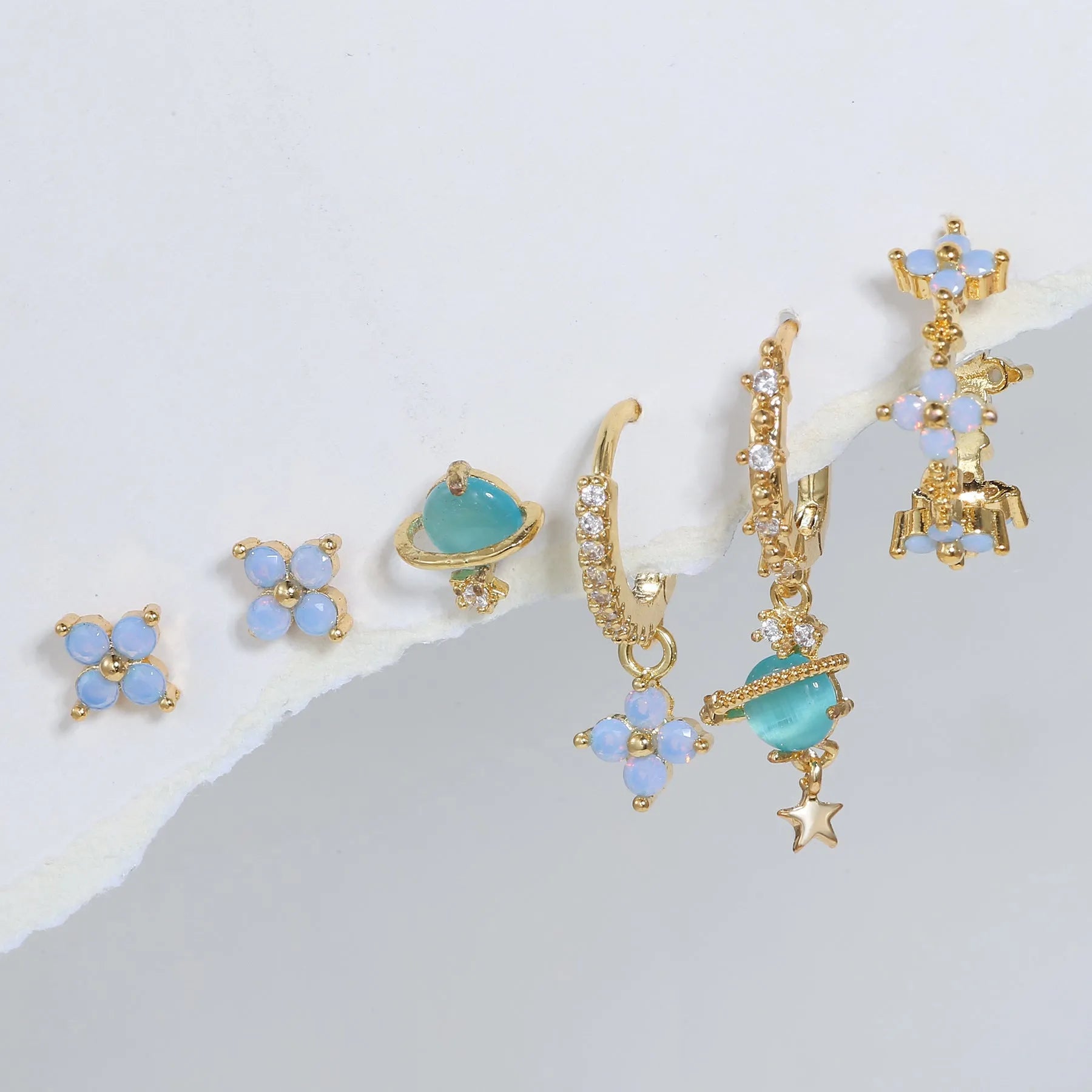 Flower-shaped stud earrings with zircon crystal centres in gold and silver colour options