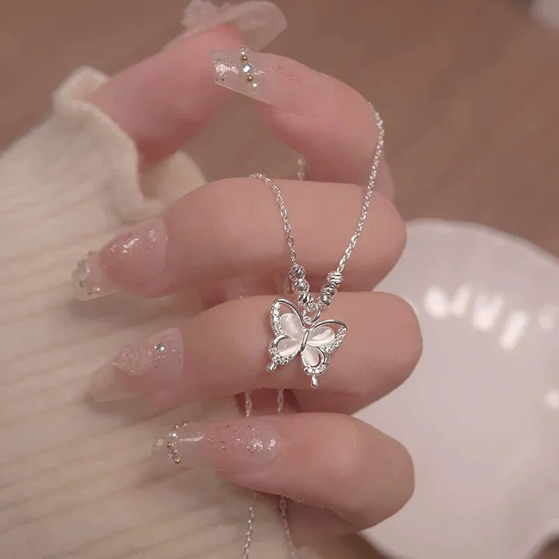 Women's silver butterfly necklace with 925 silver pendant and adjustable cross chain showing opal detail