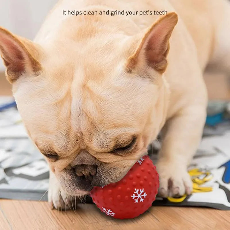 Red dog toy ball with squeaker and air vents, 7 cm diameter, floating on water