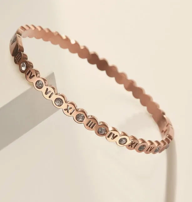 Titanium steel bracelet with number design in gold, rose gold, and steel colour options.