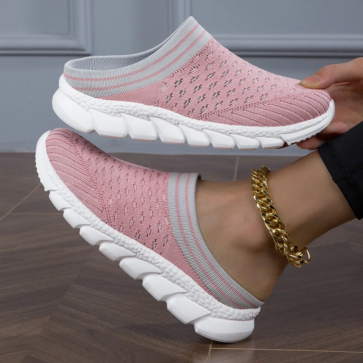 Women's black flyknit semi-slipper sock shoes with striped pattern and hollowed-out sewing lines on a lightweight sole.