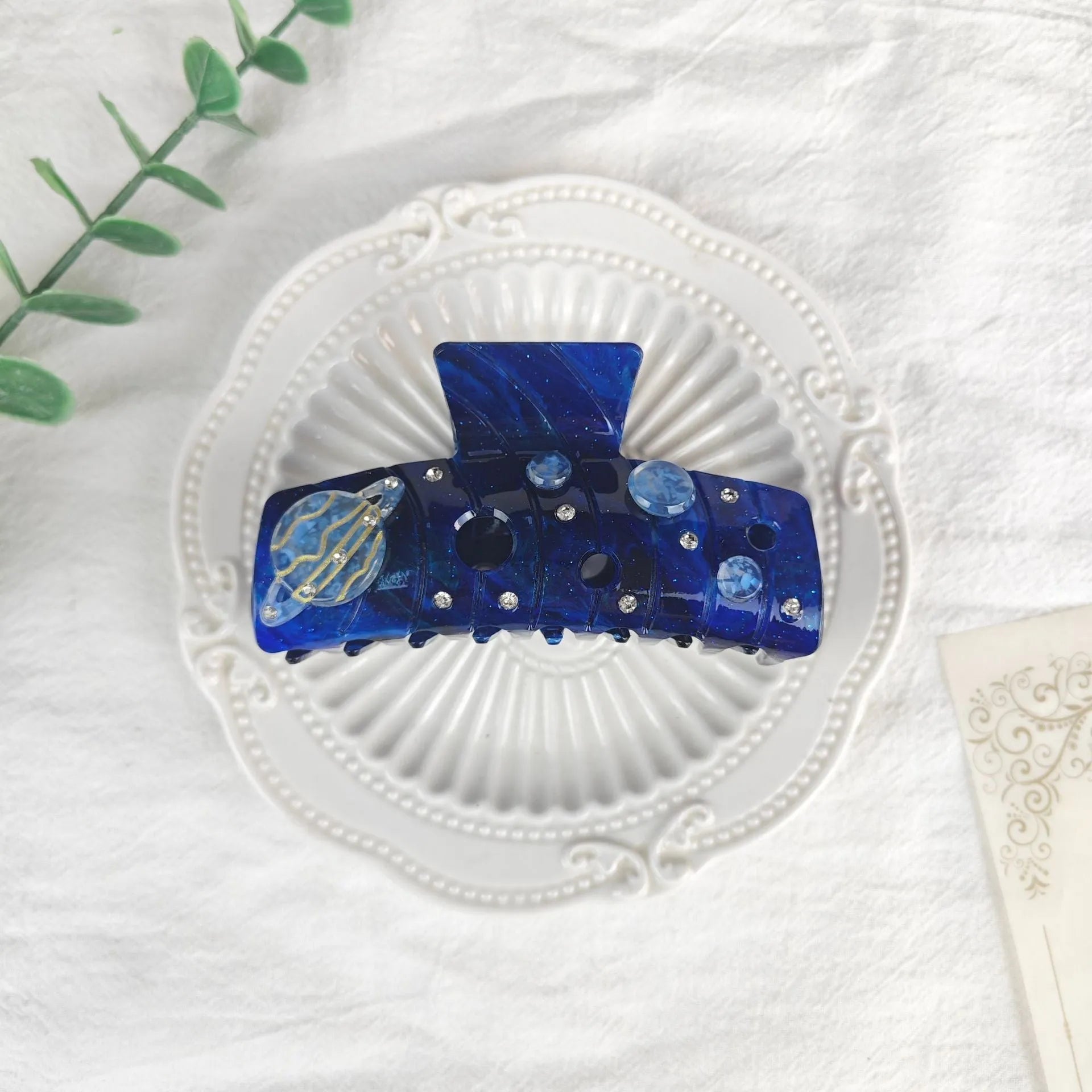 Oversized women's barrette with star moon starry sky pattern in sky blue colour.