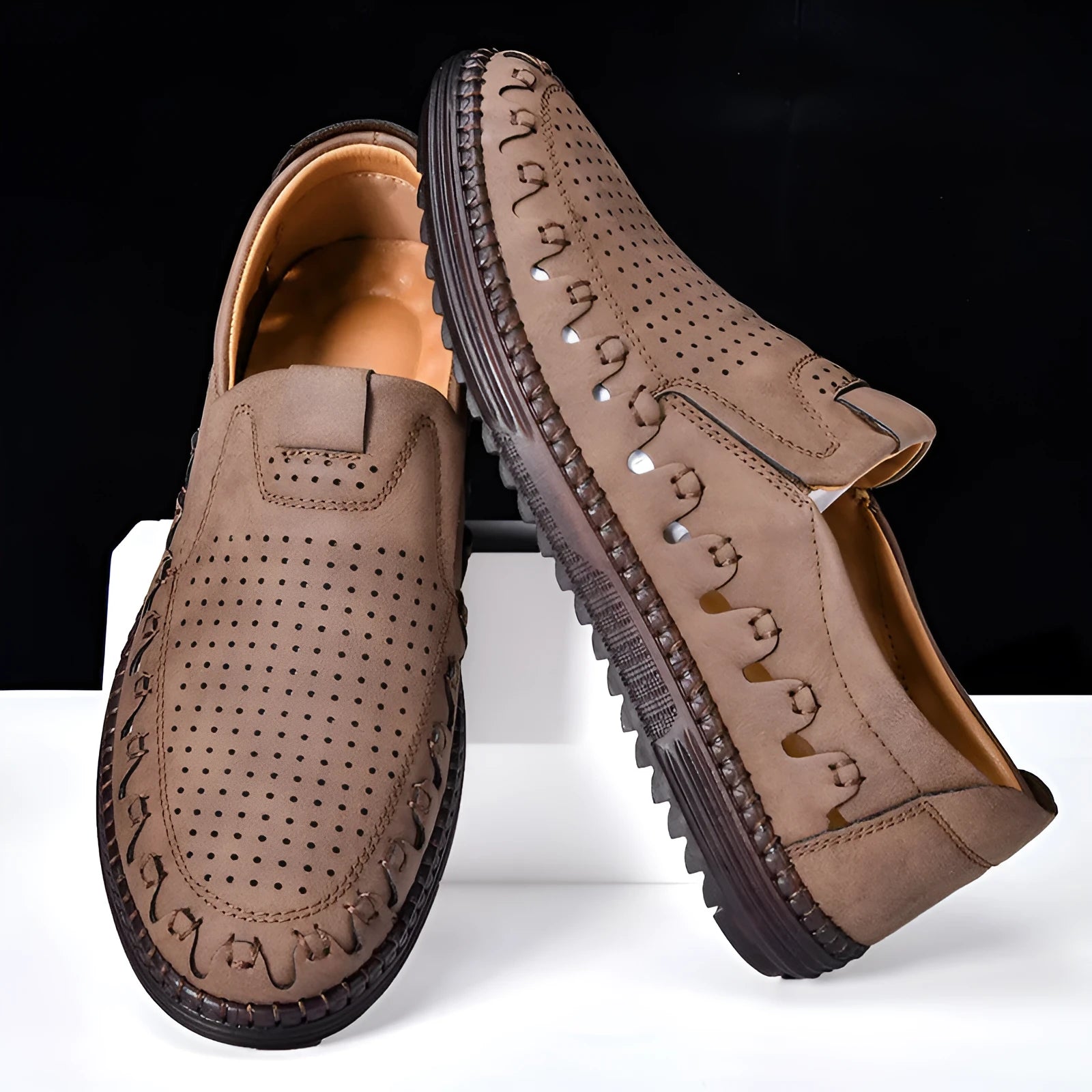 Men's brown slip-on casual leather shoes with round toe and flat heel on a white background.