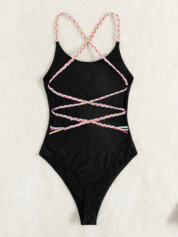 Black solid colour women's one-piece swimsuit with a backless, sleeveless design on a model.