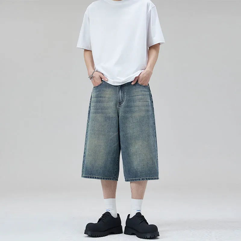 Men's loose fit straight-leg denim shorts in light blue on a plain background