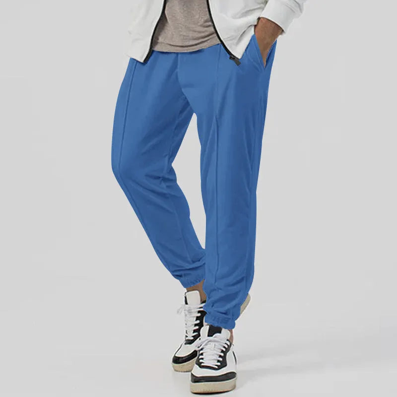 Men's loose tapered casual track sweatpants in cotton blend fabric showing straight-leg design
