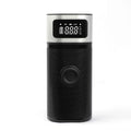 Black portable wireless air pump with USB charging cable, inflation tube, and a set of nozzles on a grey background.