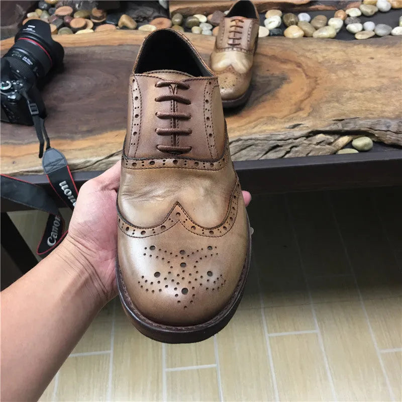 Light brown vintage engraved men's lace-up leather shoes with distressed finish and round toe.