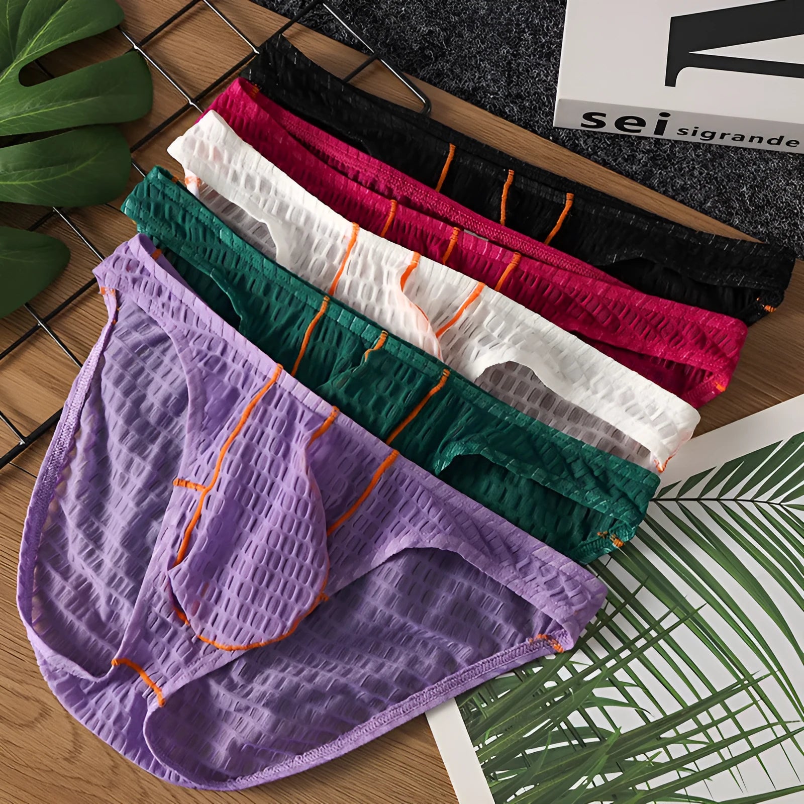 Men's low-waist lace briefs in ice silk fabric on a white background, shown in green colour.