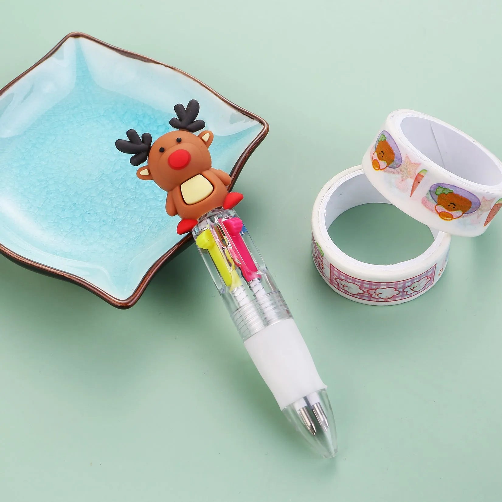 Compact 11cm Christmas-themed press-action ballpoint pen with festive designs.