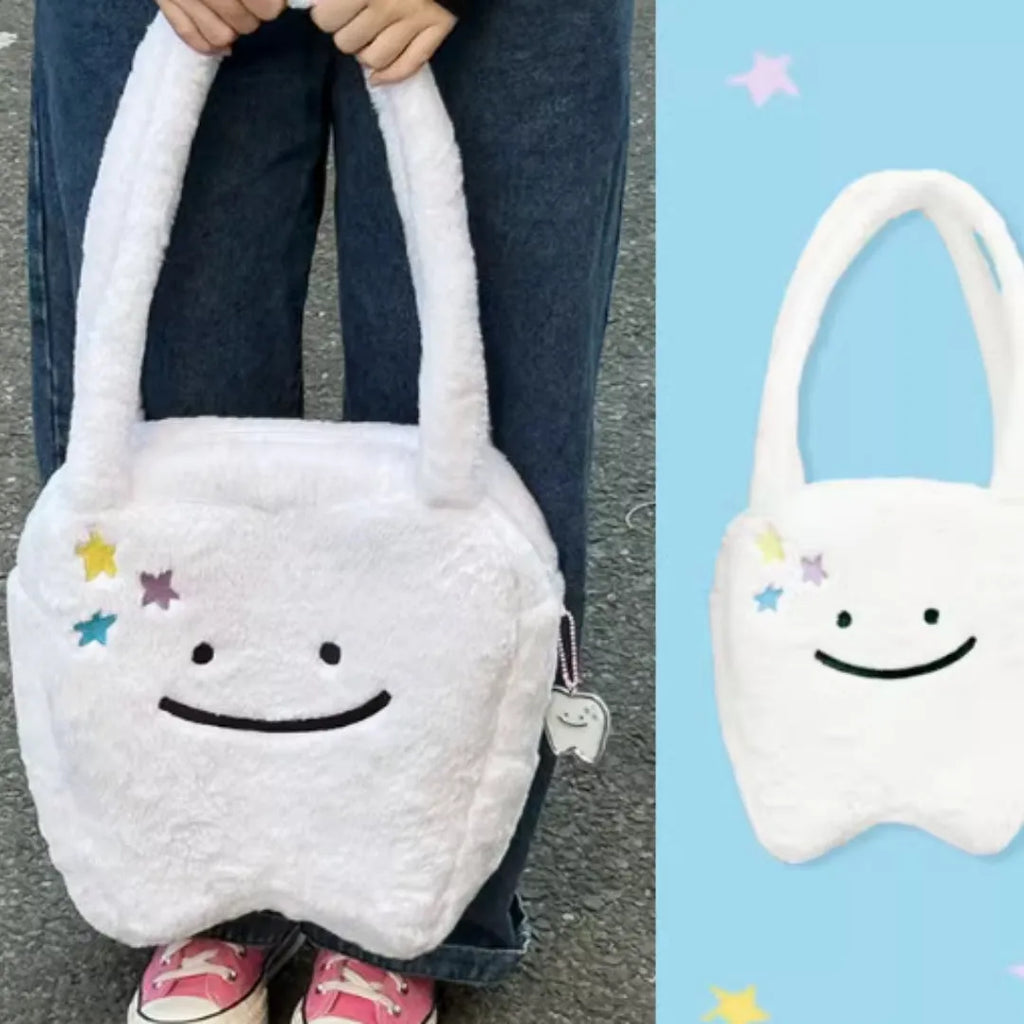 White plush shoulder tote bag with large tooth pattern decoration and zipper closure