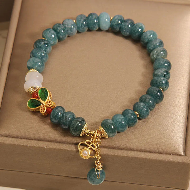 Blue water jade abacus bead bracelet with white agate and butterfly charm design
