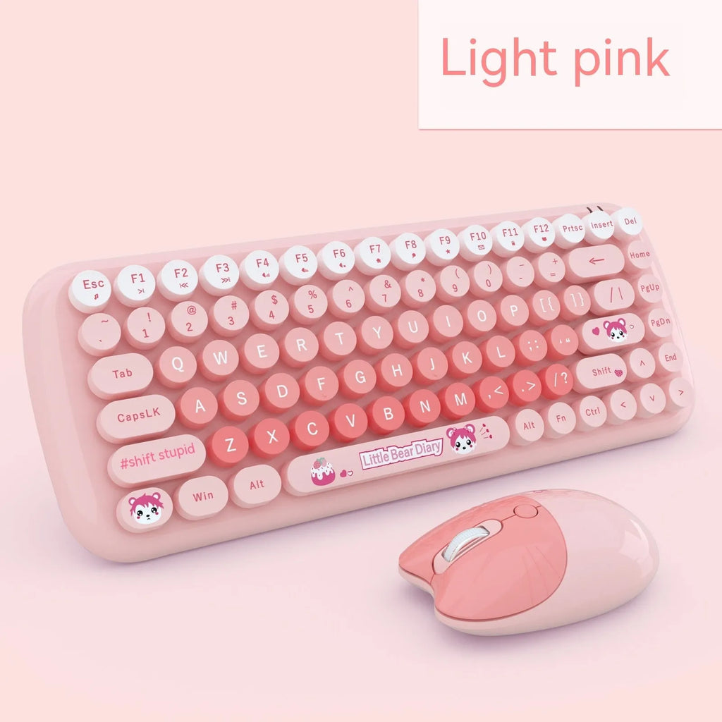 Pink mini cartoon-style wireless keyboard and mouse set on a desk with receiver.