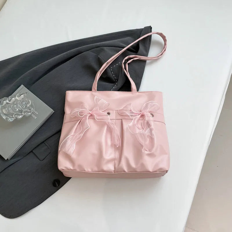 College style bow tote bag in black or pink with large capacity and internal zipper compartment