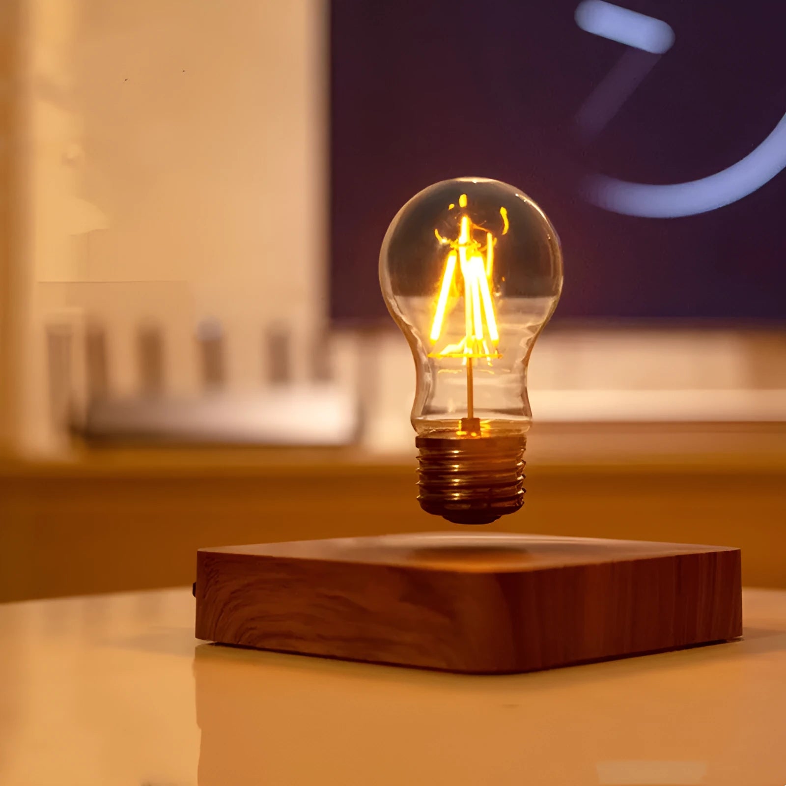 Creative minimal self-rotating maglev bulb with ABS base and warm yellow light on a desk