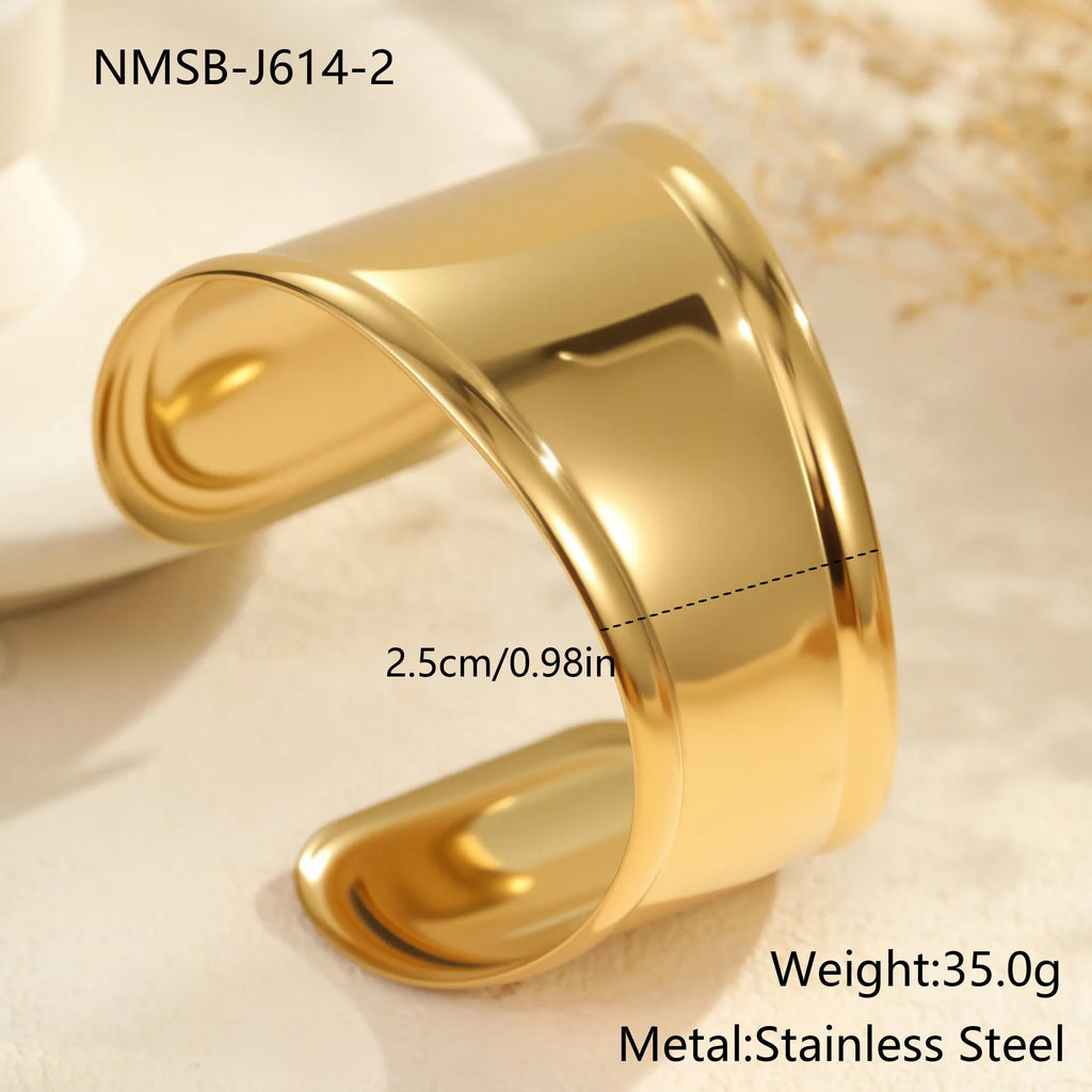 Gold plated wide stainless steel bracelet with a geometric wave shape and a niche opening.
