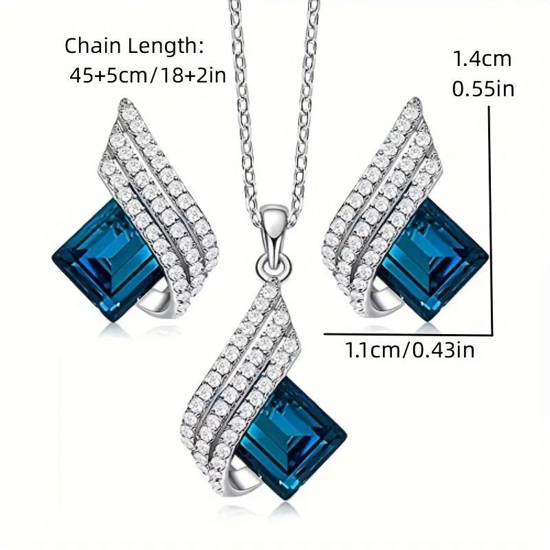 Glass pendant on an alloy cross chain necklace with matching ear studs, in two colour style options.