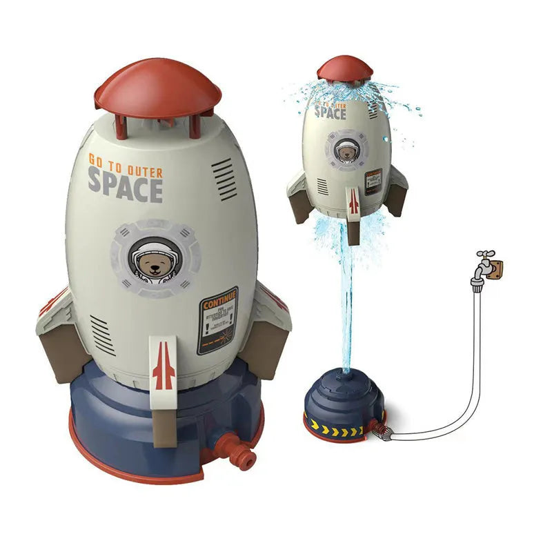Water pressure rocket launcher toy on green grass with water spray, yellow rocket, and base connector