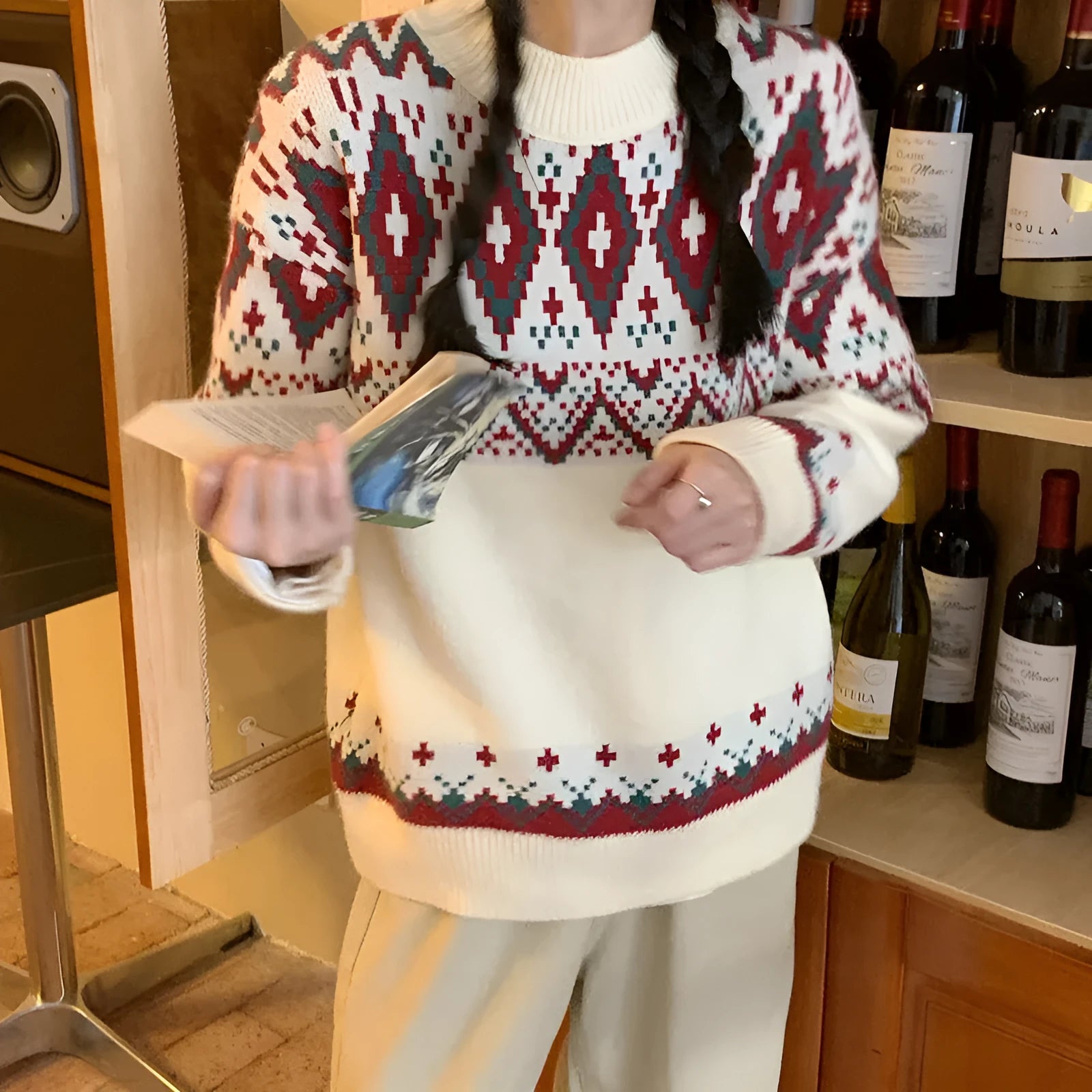 Red and white striped loose retro-style long sleeve pullover knitted top on a hanger.
