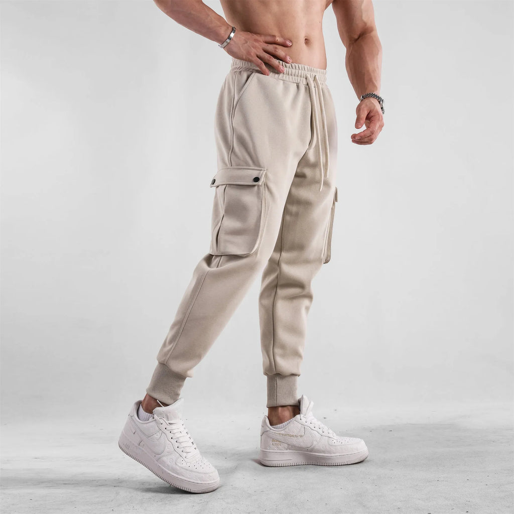 Men's loose-fit light grey cotton sports trousers with ankle tie and side pockets.
