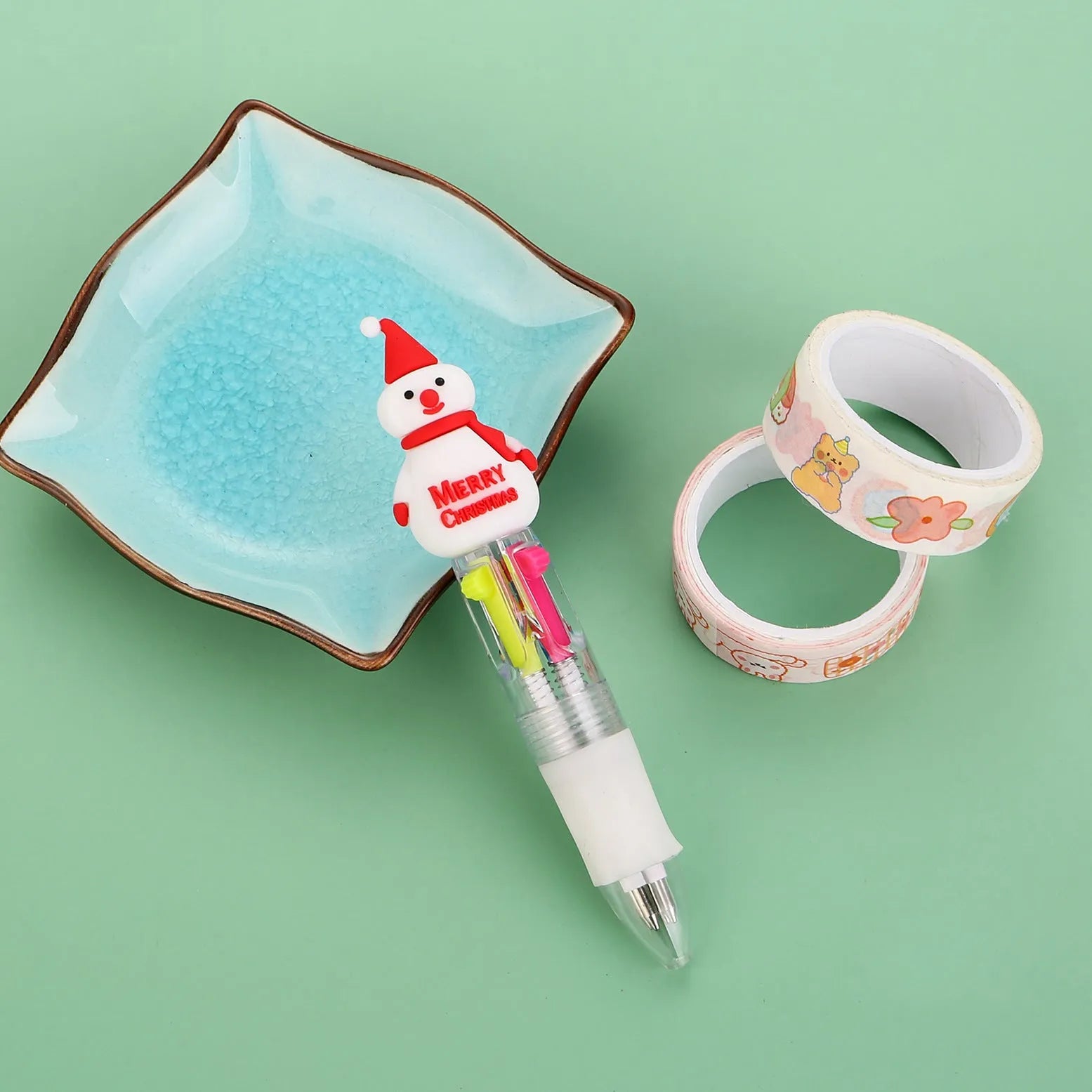 Compact 11cm Christmas-themed press-action ballpoint pen with festive designs.