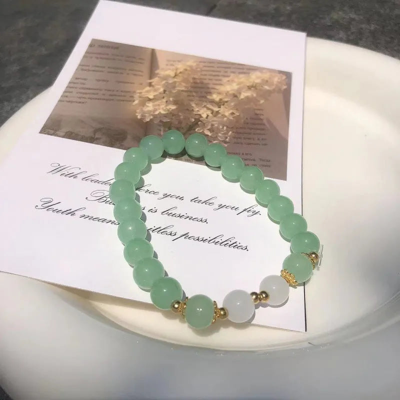 Chinese style glass bracelet with bamboo joint details in a red Lvzhu Duobao design.