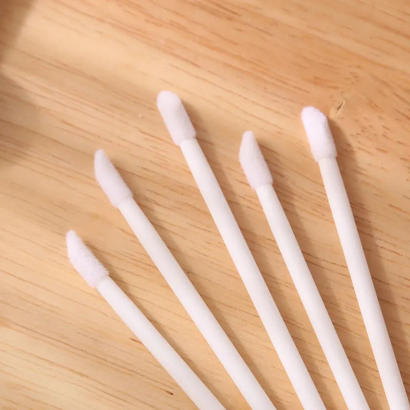 Disposable lip brushes with coloured handles and flocked brush heads for lip makeup application