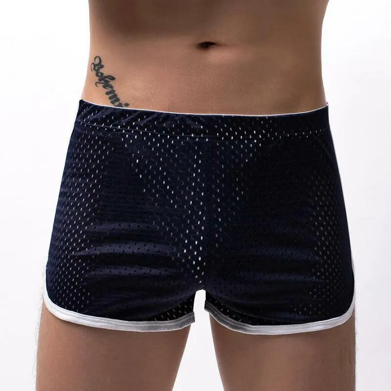Men's solid colour boxer shorts in a cotton and nylon fabric blend, shown in black, on a mid-waist fit model.