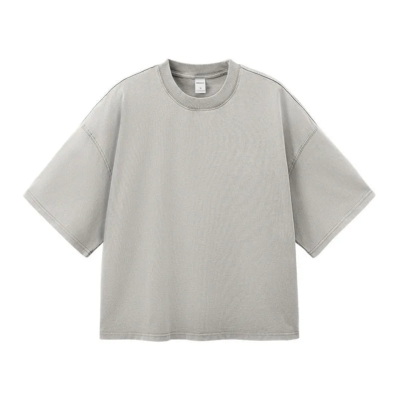 Men's vintage-style light khaki cotton t-shirt with a loose fit and drop-shoulder sleeves on a hanger.