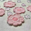 Set of hand-woven wool coasters on a wooden table surface
