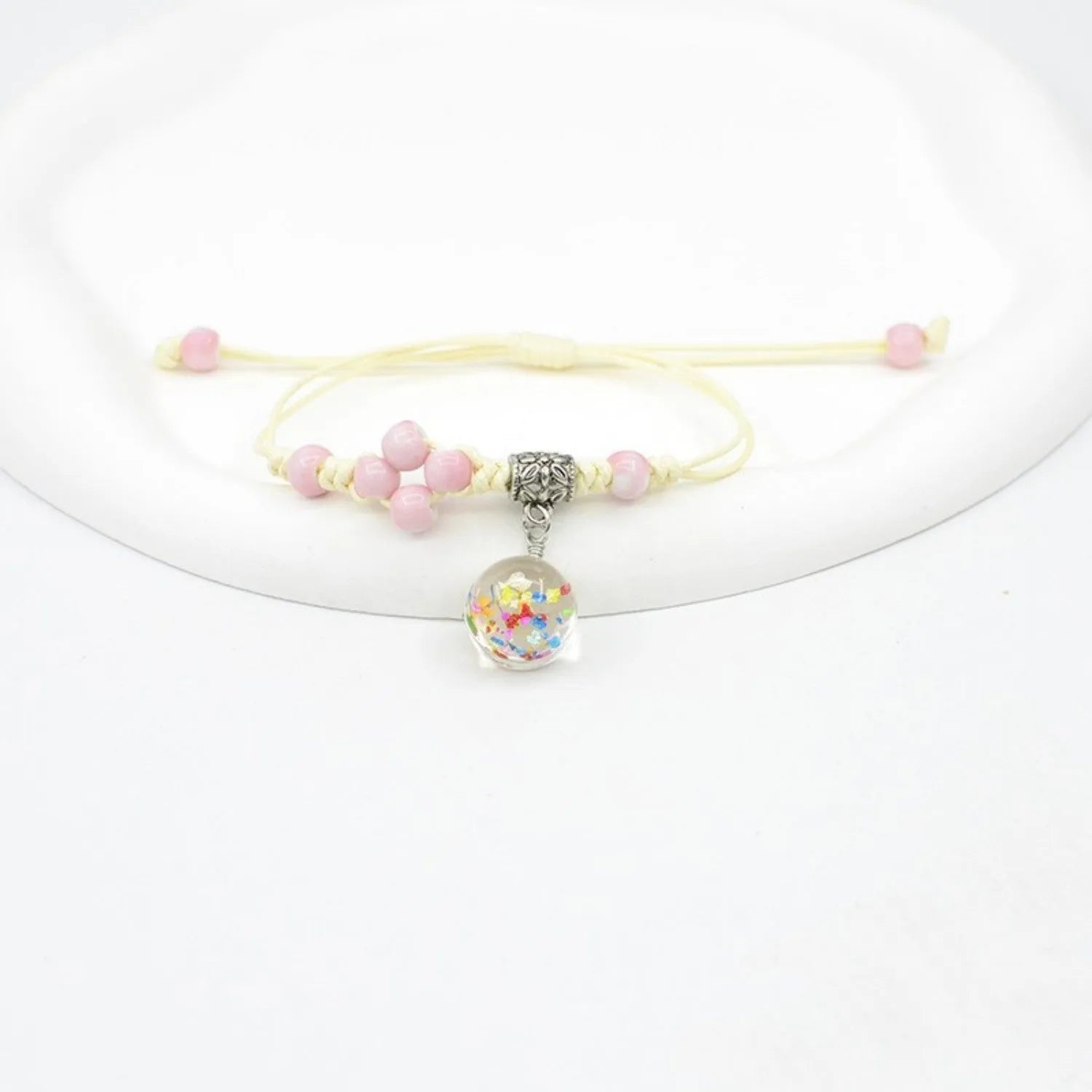 Hand-woven glass bracelet with 1.4cm beads containing real dried flowers in various colours