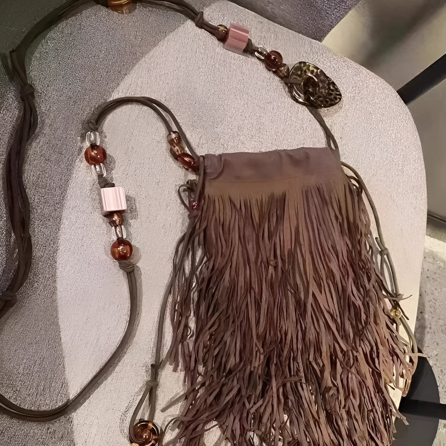 Maroon drawstring beaded tassel crossbody bag with soft plush exterior and single shoulder strap