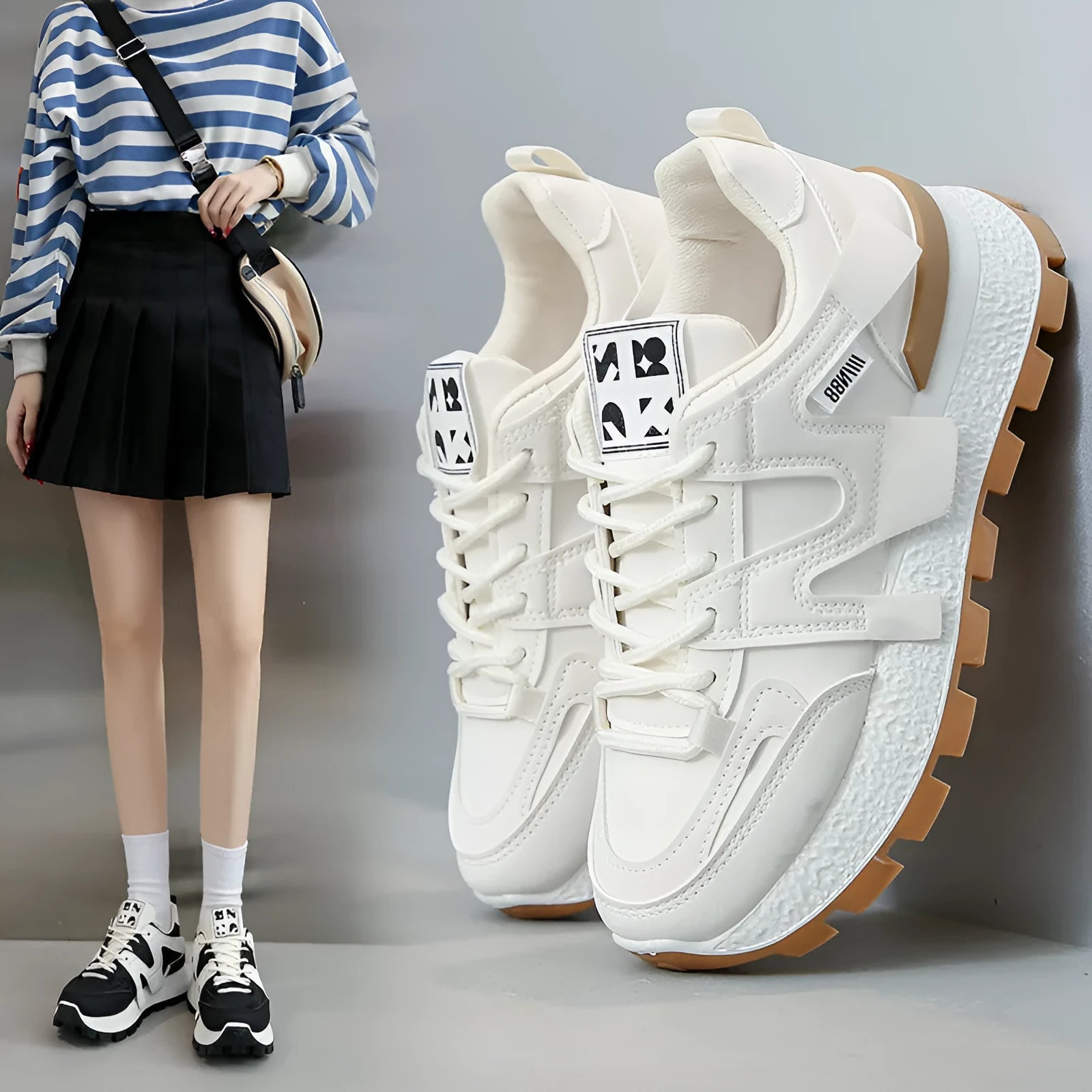 A pair of solid-colour low-top lace-up sneakers with a round toe and flat rubber sole.